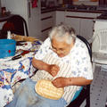 Mary George working on baskets in her kitchen.  Photo courtesy of Rita Pimlott.
